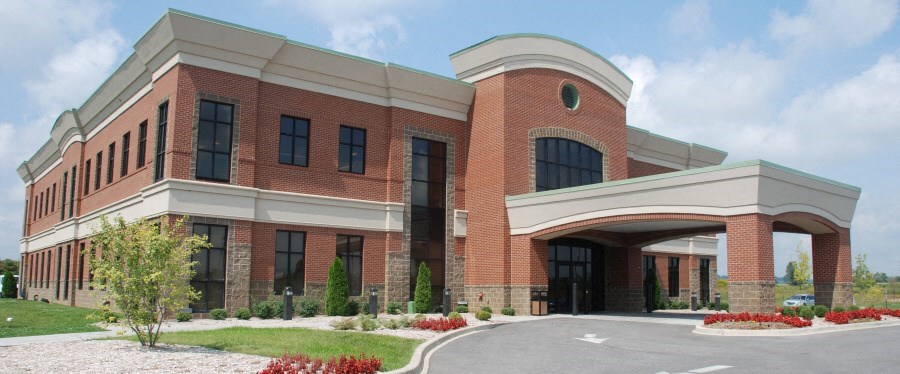 a rendering of a brick building with an overpass