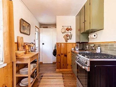 a kitchen with a stove and a stove top oven