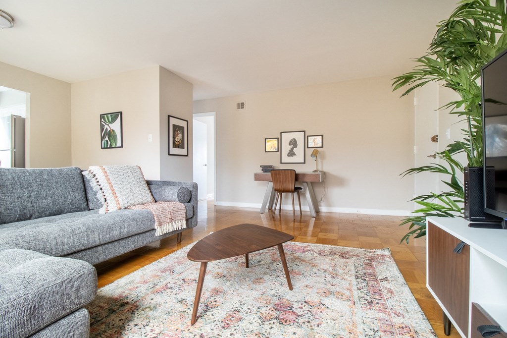a living room with a couch and a coffee table and a tv