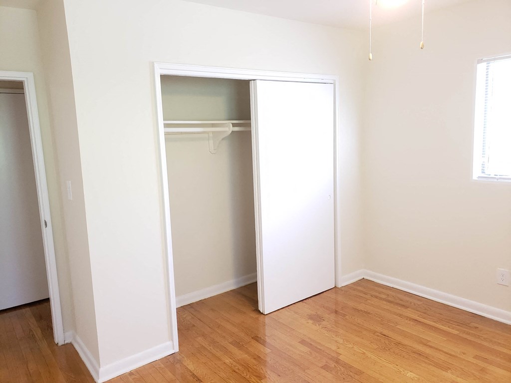 a room with a wardrobe and a wooden floor and a closet