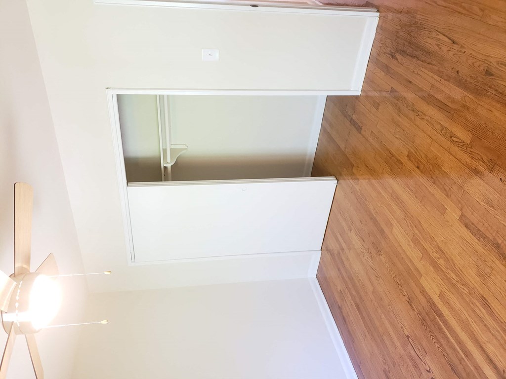 a view from the top of an open staircase with a wood floor