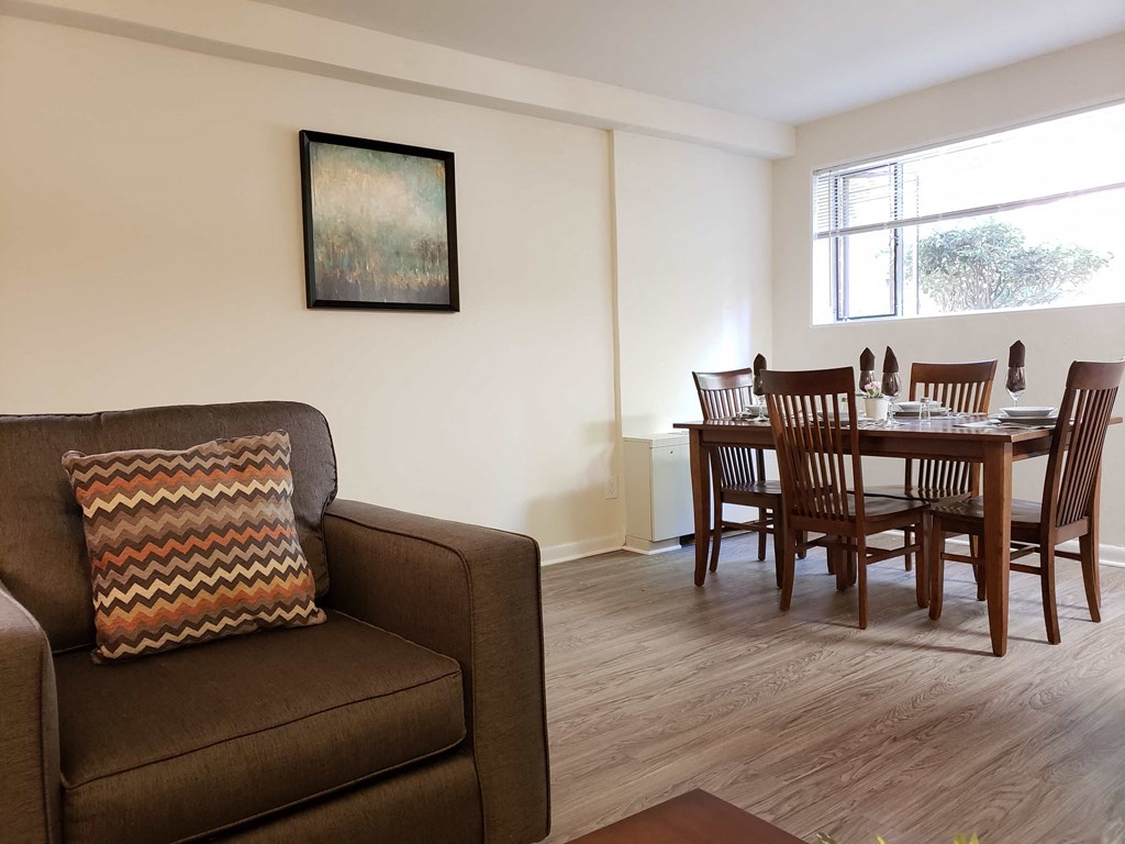 a living room and dining room with a table and a couch