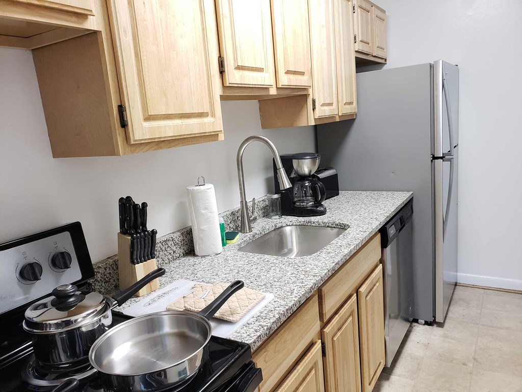 a kitchen with a sink and a refrigerator