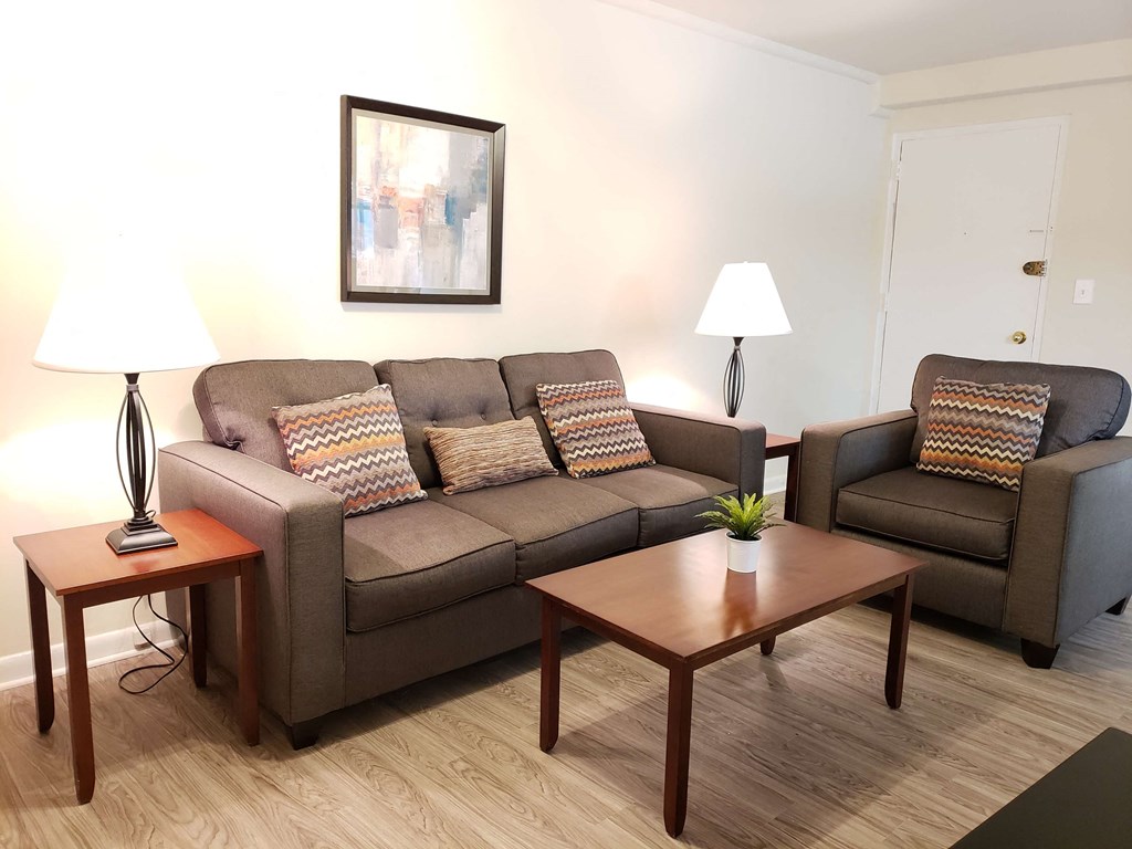 a living room with a couch and two tables