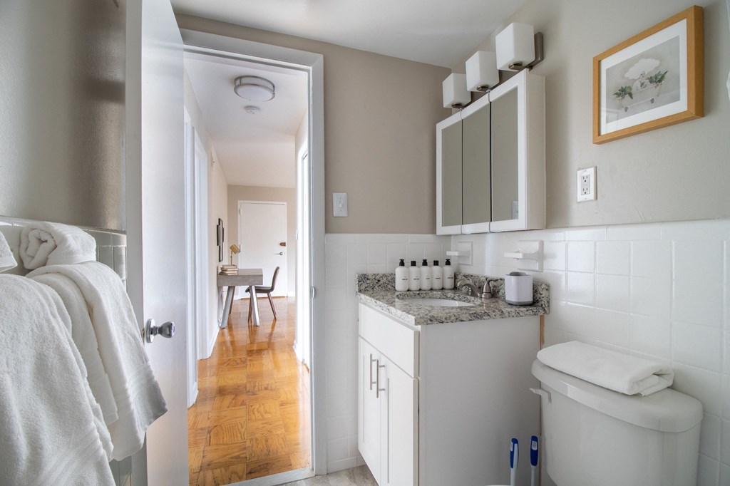 a small bathroom with a toilet and a sink and a mirror