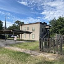an old building with a wooden fence in front of it