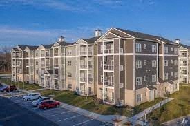 a row of apartment buildings next to a parking lot