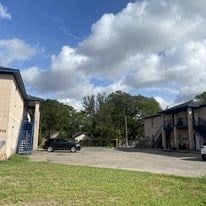 a car parked in a parking lot next to a building