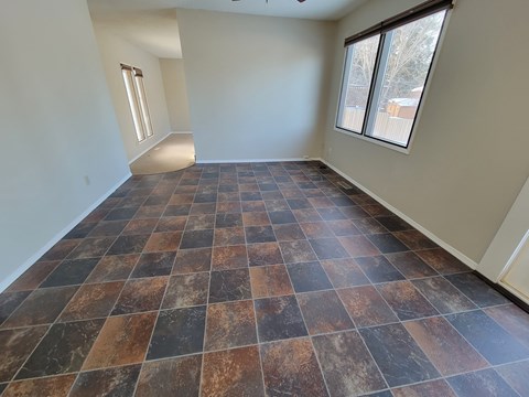 A room with a checkered floor and a window.