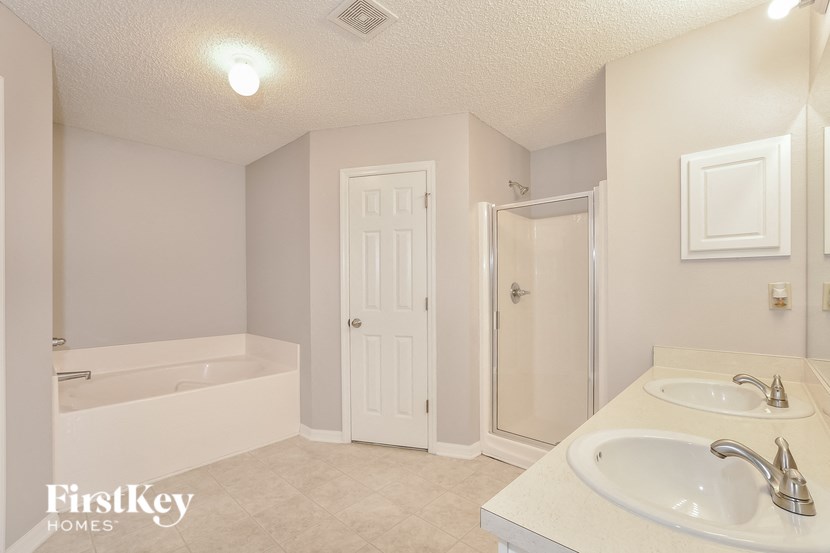 a bathroom with a sink and a shower and a bath tub