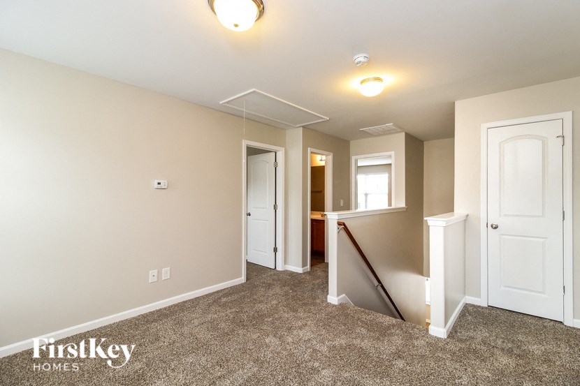 A room with a carpet floor and a window.
