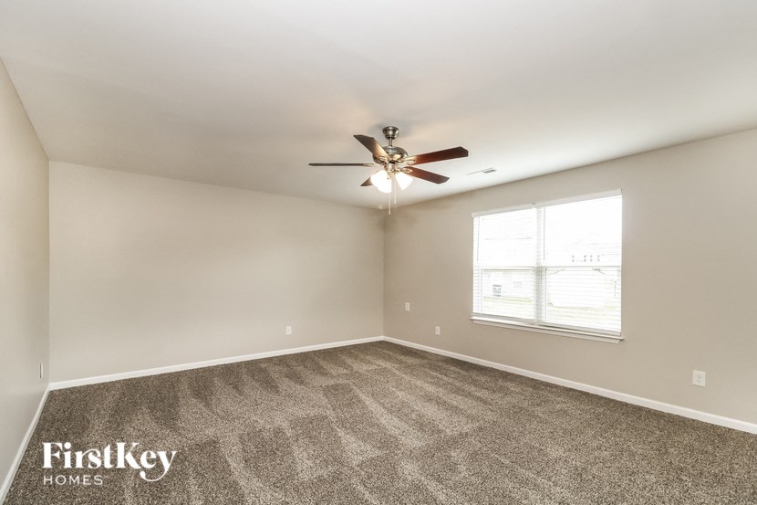 A room with a fan and a window.