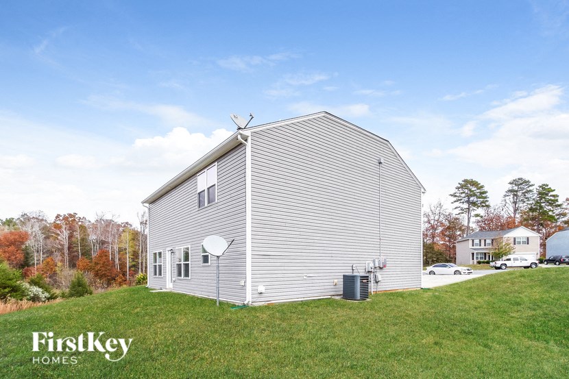A house with a grey siding and a white roof is shown with the words "FirstKey Homes" on the bottom left.