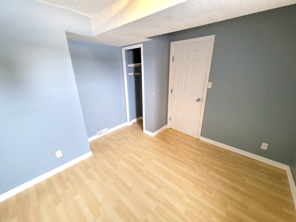 a renovated living room with wood floors and blue walls