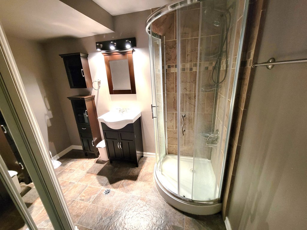 a small bathroom with a shower and a sink