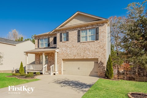 A house with a garage and a porch is for sale.