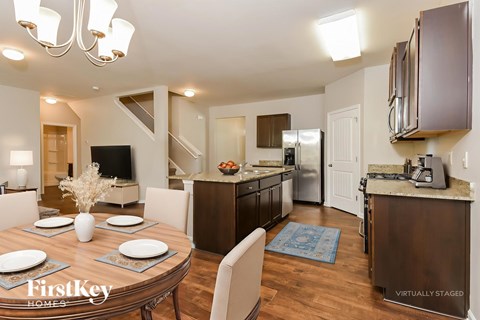 A modern kitchen with a dining table set for four.