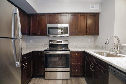 a kitchen with a stove microwave and sink