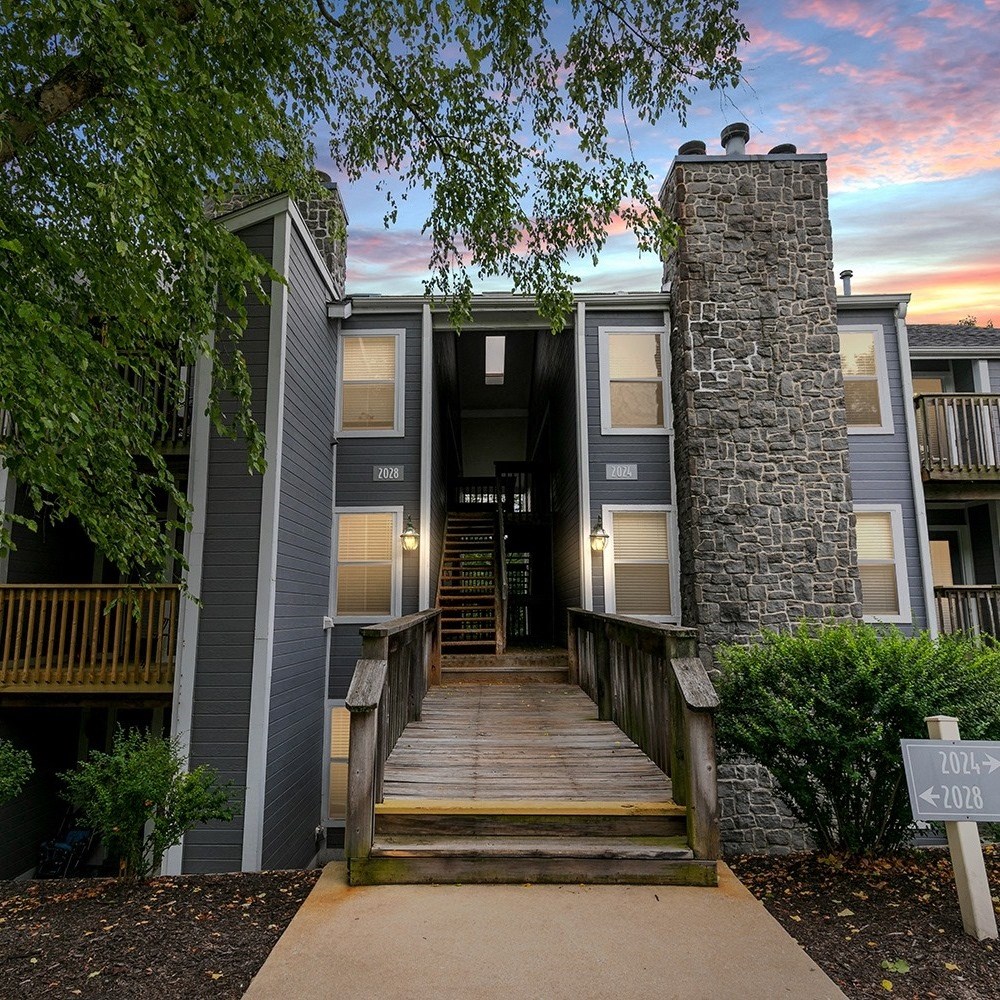 a view of a building with a sunset behind it