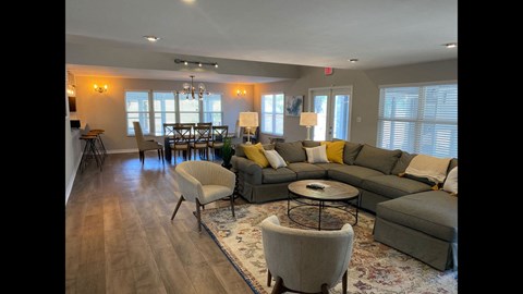 a living room with couches and chairs and a table
