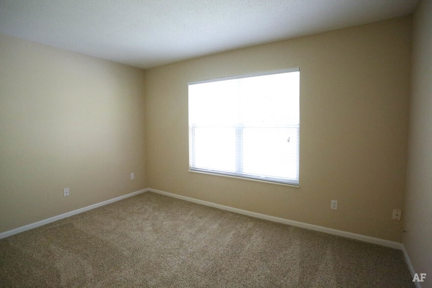 a room with carpet and a large window