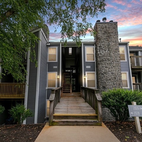 a view of a building with a sunset behind it