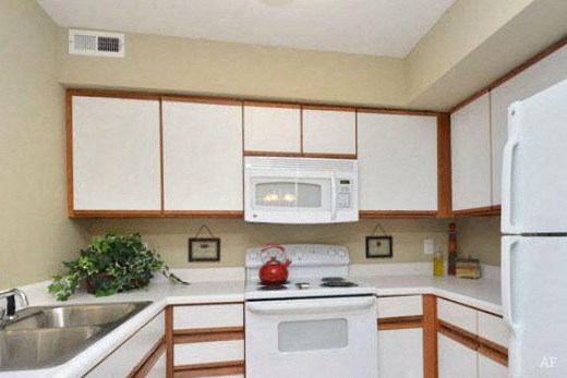a kitchen with white appliances and white cabinets