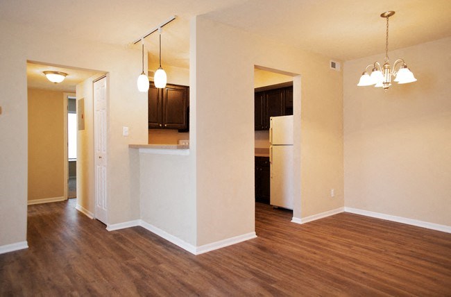 a living room and kitchen with a wood floor