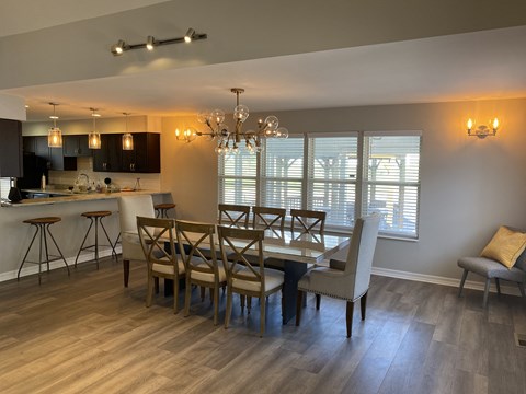 a dining room and kitchen with a table and chairs