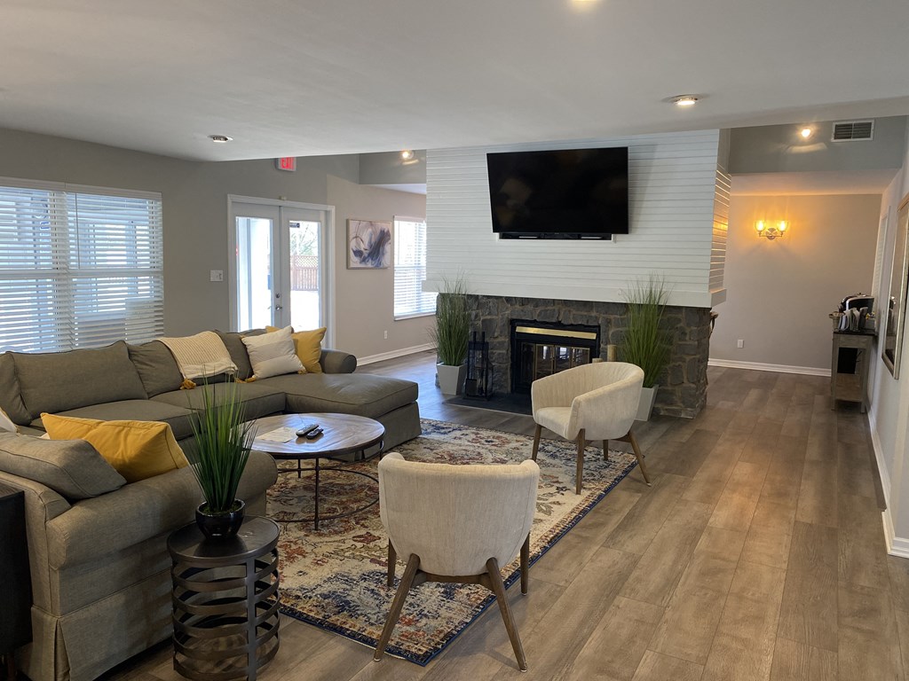 a living room with a couch and chairs and a fireplace