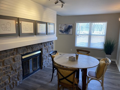 a dining room with a table and a fireplace