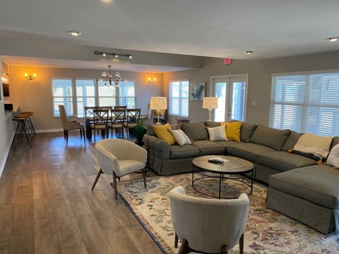 a living room with couches and chairs and a dining room table