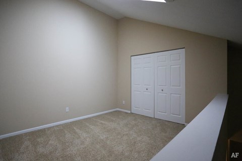 a room with a carpeted floor and a white door