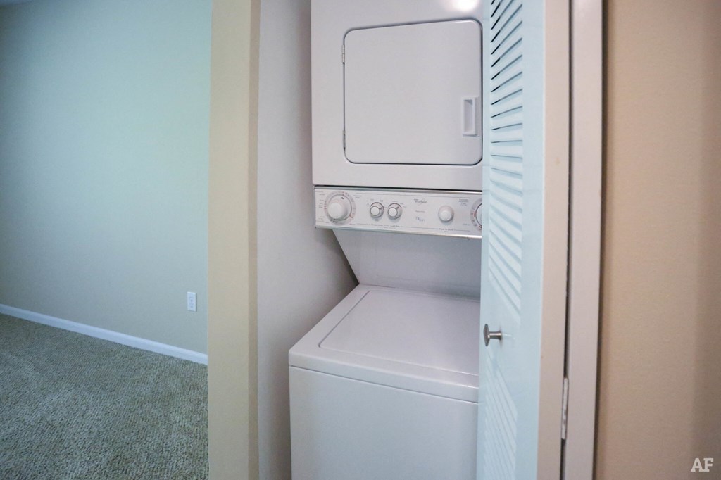 an empty laundry room with a washer and dryer