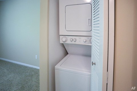 an empty laundry room with a washer and dryer