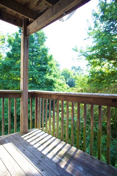 a deck with a view of the trees