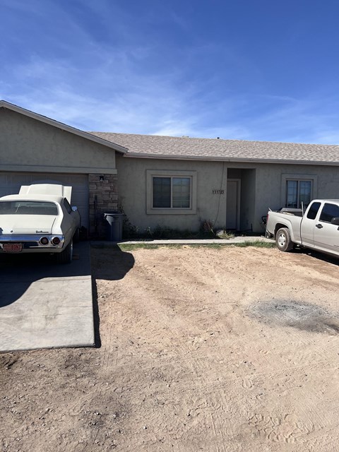 a house with two cars parked in front of it
