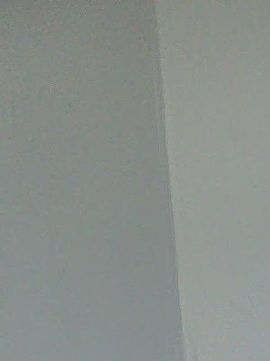 A room with wooden floors and a white door.