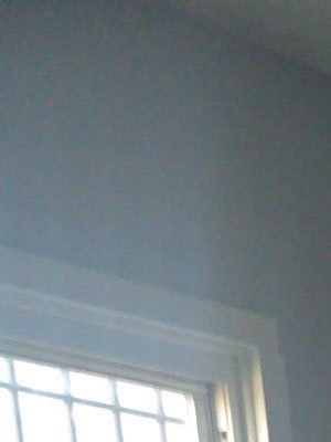 A room with wooden floors and a window.