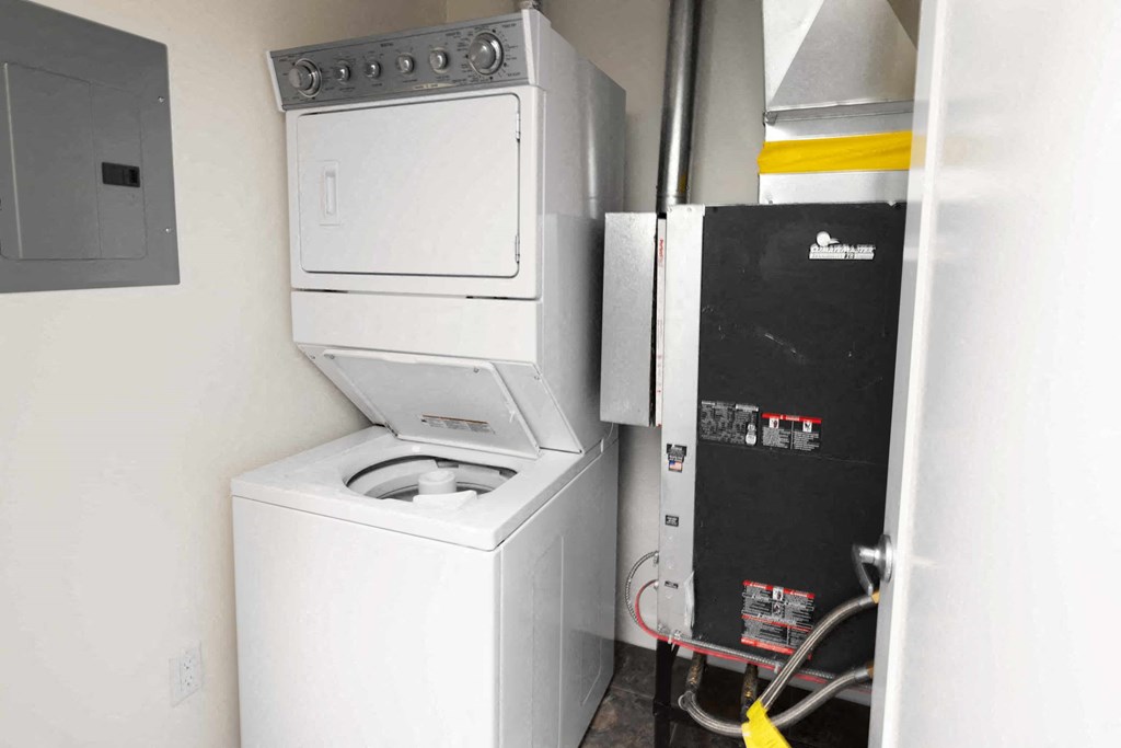 a white washer and dryer in a room with a refrigerator