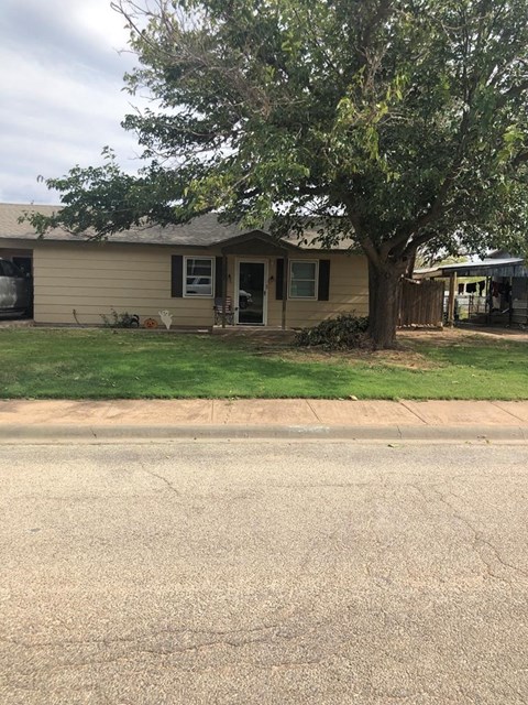 A house with a tree in front of it.