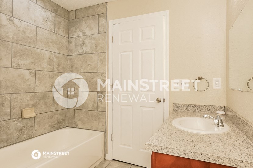 a bathroom with a sink and a bath tub