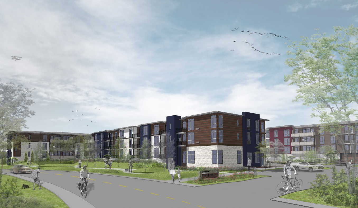 A street view of a residential area with apartment buildings and people riding bicycles.