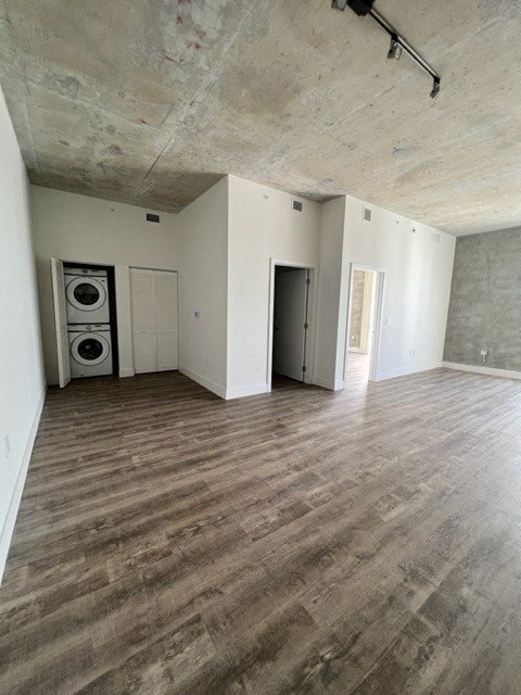 an empty living room with white walls and wood floors