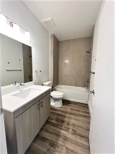 a bathroom with a toilet and a sink and a mirror
