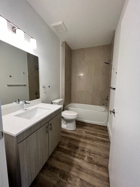 a bathroom with a toilet sink and a mirror