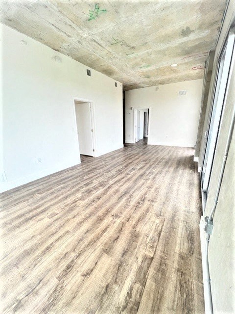 a empty room with a wood floor and white walls