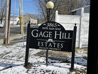 a sign in front of a gate hill estates sign