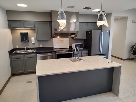 a large kitchen with gray cabinets and a counter top