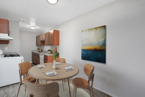 A dining room with a round table and chairs.